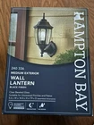 Hampton Bay 14.5 In Black Dusk Dawn Outdoor Exterior Wall Lantern Light Open. Price: $55.09.